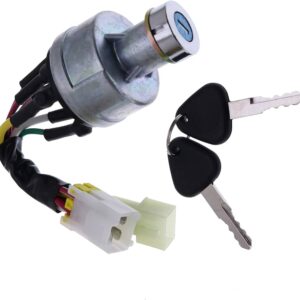 A metal ignition switch for heavy machinery with a wiring harness and two black-handled keys on a ring.
