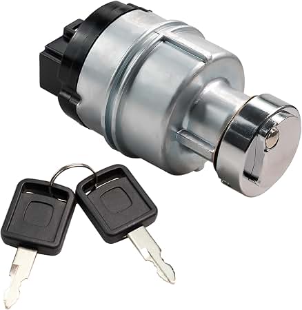 A metallic cylindrical ignition switch for heavy machinery shown with two matching black keys on a ring.