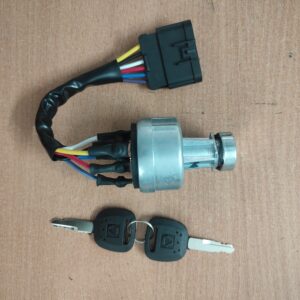 A metal ignition switch for heavy machinery with a multi-wire harness and two matching black keys.